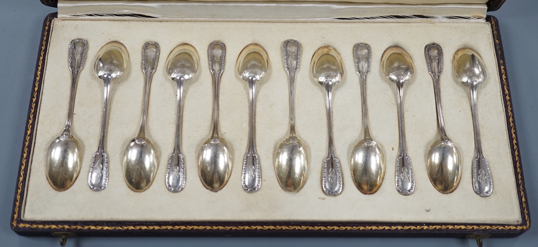 A cased set of twelve early 20th century French 950 white metal teaspoons by Emile Puiforcat, retailed by Louis Rey, 10.5cm.